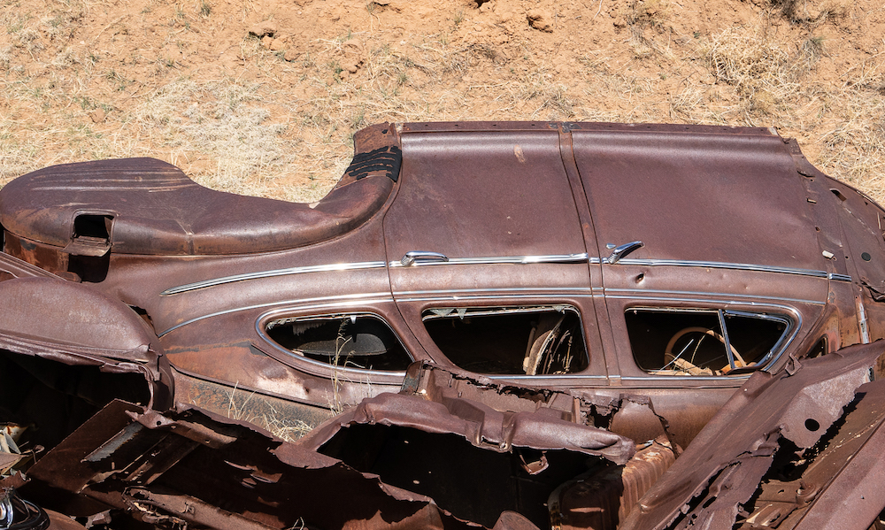 abandoned vehicle, abandoned car, cars, autos, rust, junk, erosion control, New Mexico, The Road not Taken Enough, headlight, dashboard, chassis, chrome